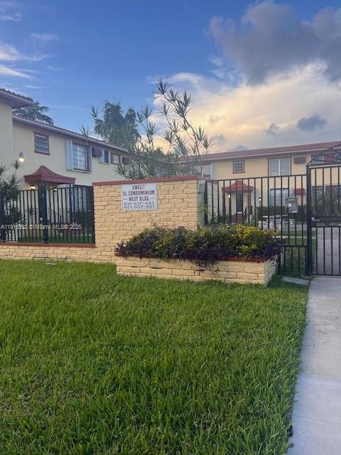 651 Southwest 11th Street, Unit 15W Miami, FL 33129 - Photo 2 of 24 a view of a house with a yard and a garden