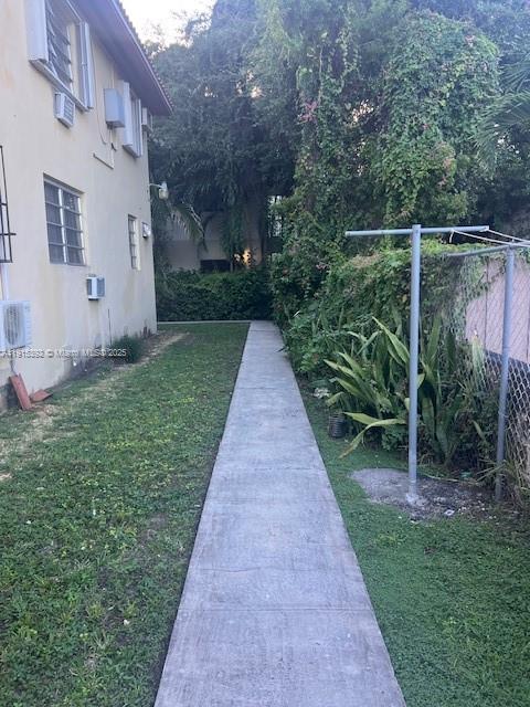 651 Southwest 11th Street, Unit 15W Miami, FL 33129 - Photo 21 of 24 a view of a pathway with house on both side