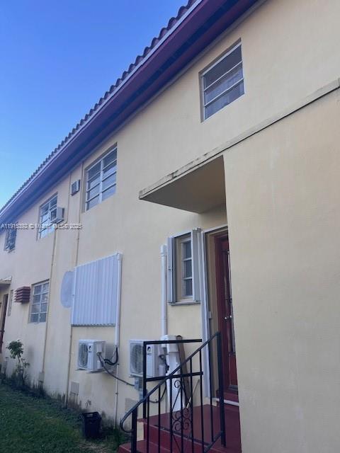 651 Southwest 11th Street, Unit 15W Miami, FL 33129 - Photo 22 of 24 a view of a patio with couches and table and chairs with wooden floor