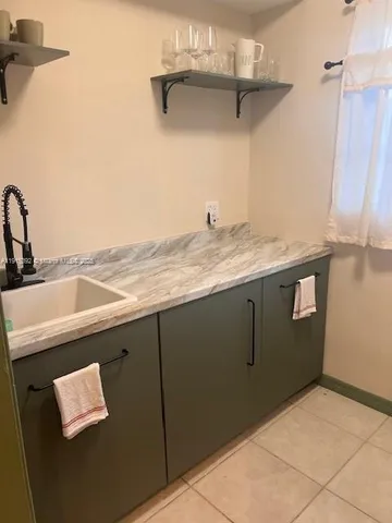 a kitchen with a sink and cabinets