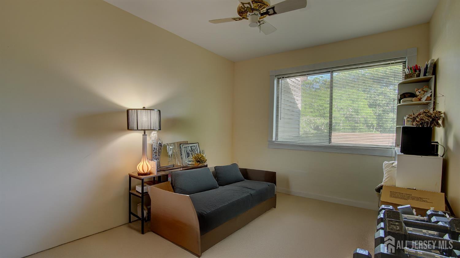 86 Arrowood Road, Unit G Manalapan, NJ 07726 - Photo 11 of 16 a living room with furniture and a flat screen tv