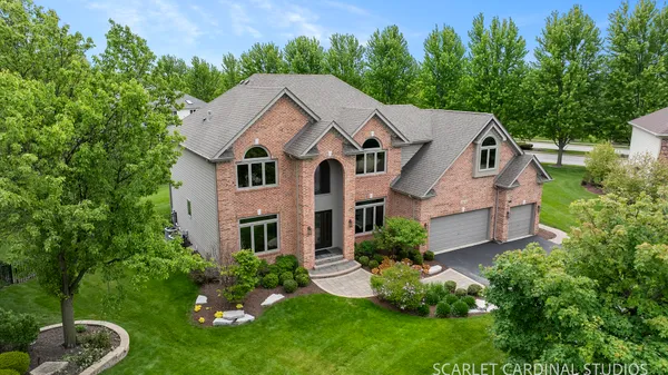 a aerial view of a house next to a yard
