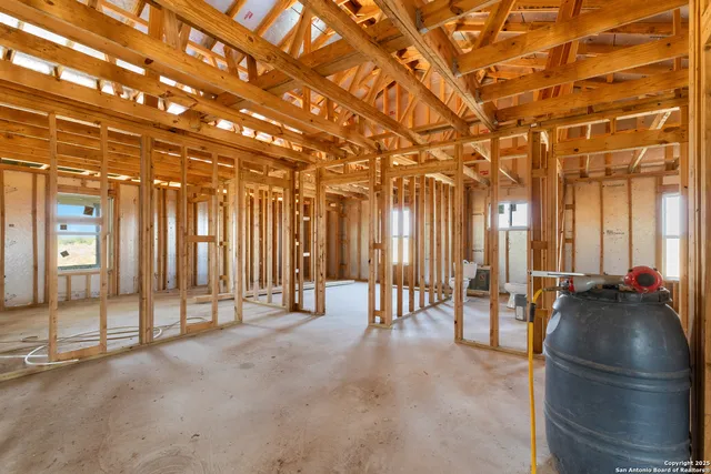 a view of a room with lots of chairs and mirrors
