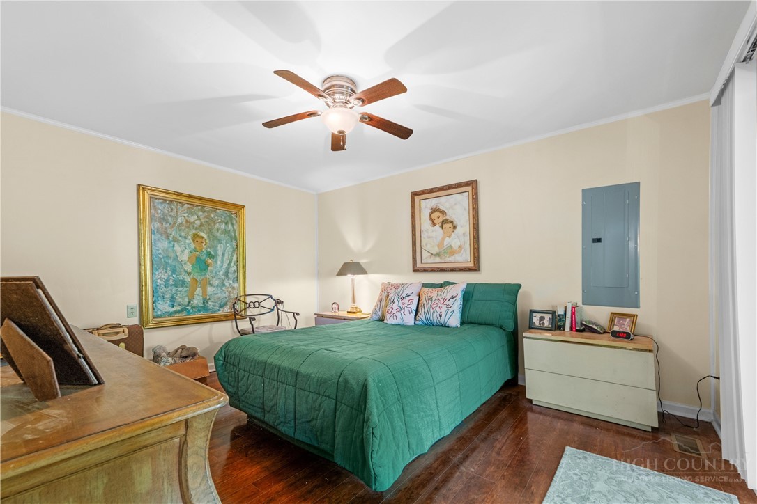 467 Horseshoe Ridge Road East Deep Gap, NC 28618 - Photo 26 of 46 a bedroom with a bed and a chandelier
