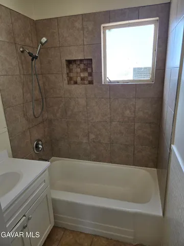 a bathroom with a bathtub and window