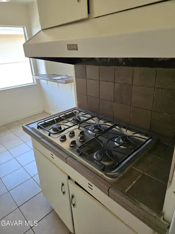 a stove top oven sitting inside of a kitchen