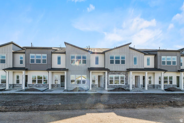 2995 South 265th Street West, Unit 752 Logan, UT 84321 - Photo 2 of 21 Contemporary townhome row featuring multi-toned siding, stone accents, and varied rooflines