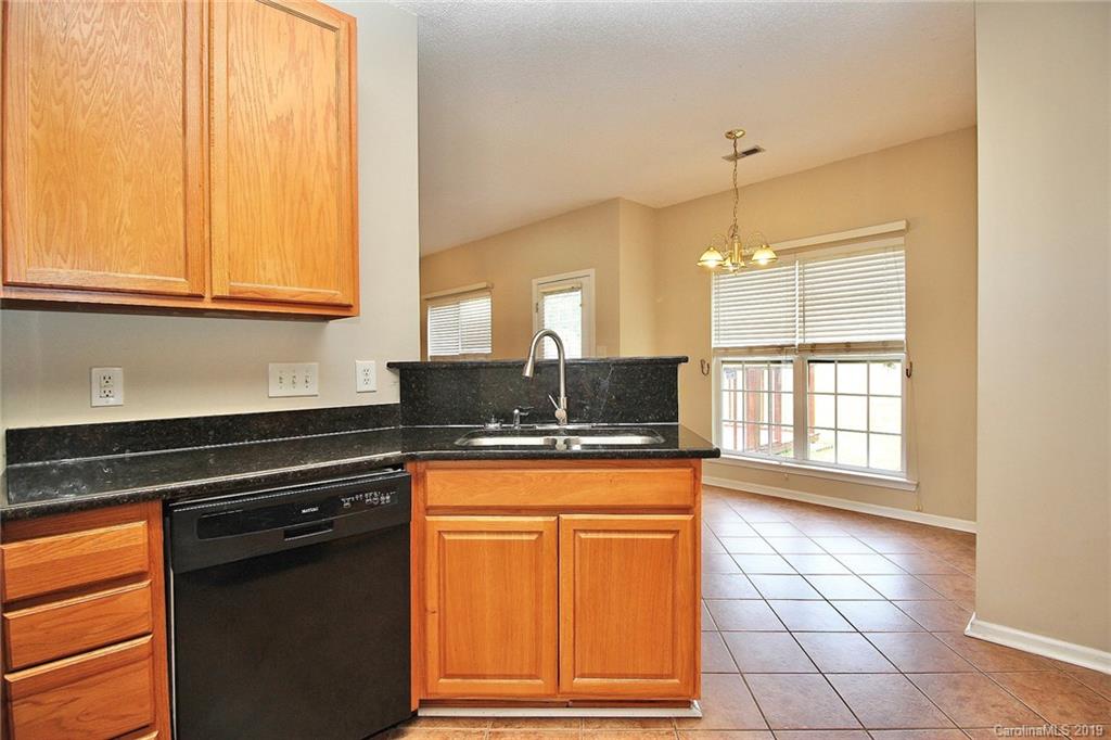 8207 Fox Swamp Road Charlotte, NC 28215 - Photo 15 of 44 a kitchen with stainless steel appliances granite countertop a stove a sink and a microwave