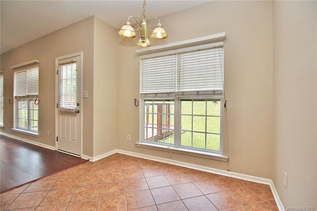 8207 Fox Swamp Road Charlotte, NC 28215 - Photo 17 of 44 a view of an empty room with a window and wooden floor
