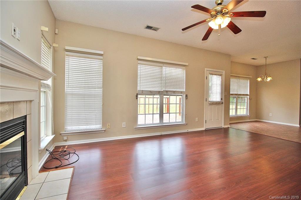 8207 Fox Swamp Road Charlotte, NC 28215 - Photo 22 of 44 a view of an empty room with window and wooden floor