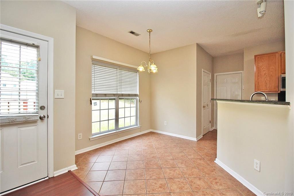 8207 Fox Swamp Road Charlotte, NC 28215 - Photo 23 of 44 a view of a kitchen with an empty space and a window