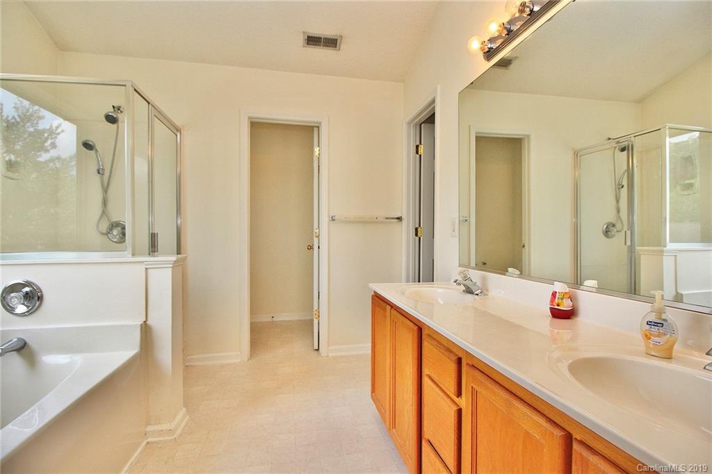 8207 Fox Swamp Road Charlotte, NC 28215 - Photo 26 of 44 a spacious bathroom with a tub sink and mirror