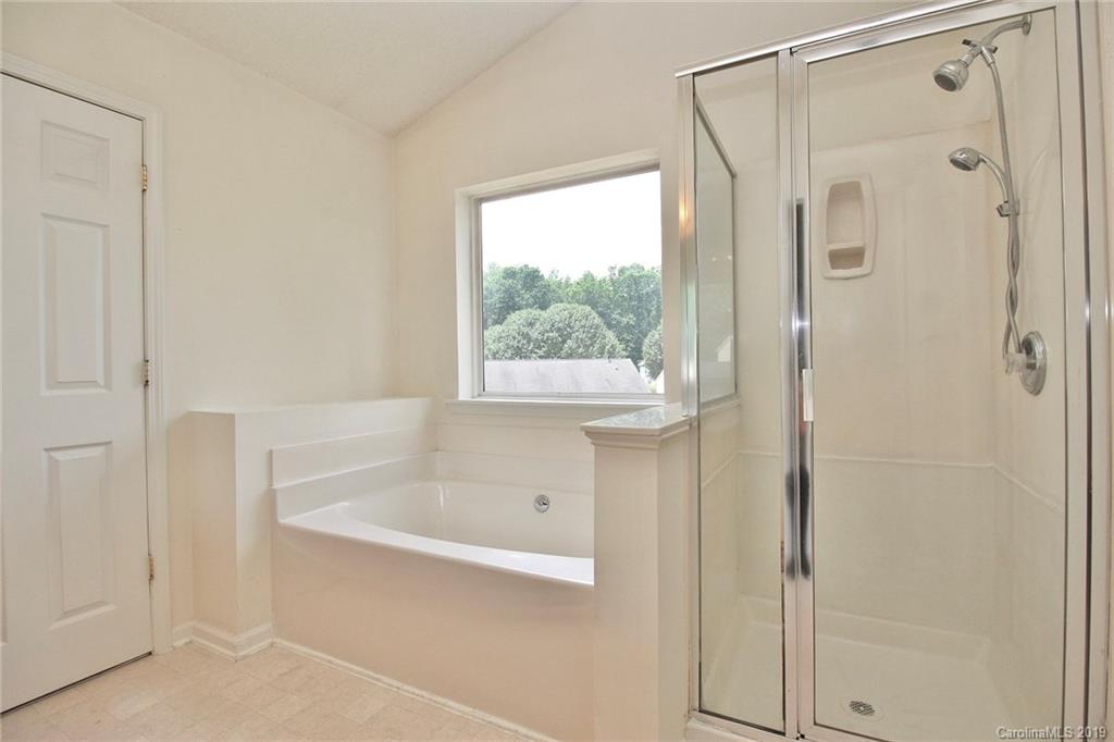 8207 Fox Swamp Road Charlotte, NC 28215 - Photo 28 of 44 a bathroom with a bathtub and a shower