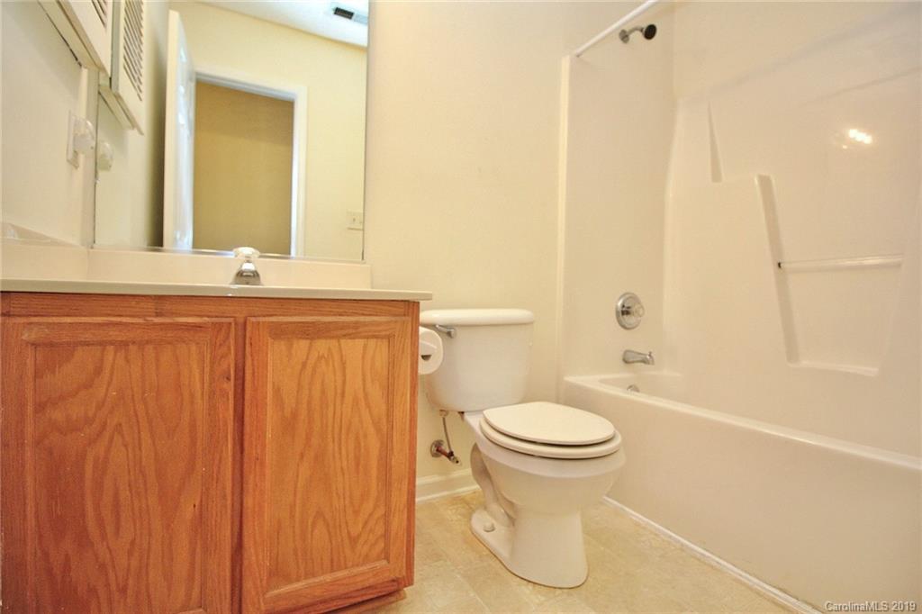 8207 Fox Swamp Road Charlotte, NC 28215 - Photo 31 of 44 a bathroom with a sink a toilet and shower