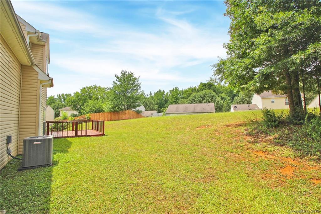 8207 Fox Swamp Road Charlotte, NC 28215 - Photo 40 of 44 a view of a swimming pool with an outdoor space and seating area