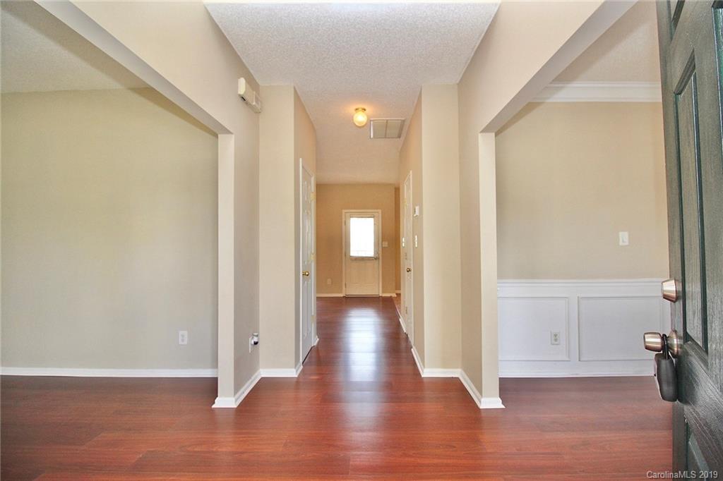 8207 Fox Swamp Road Charlotte, NC 28215 - Photo 5 of 44 a view of a hallway with wooden floor