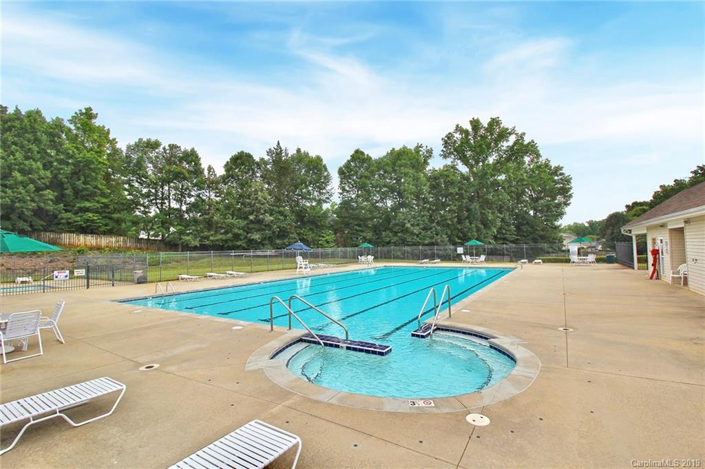 8207 Fox Swamp Road Charlotte, NC 28215 - Photo 43 of 44 a view of a swimming pool with a yard and large trees
