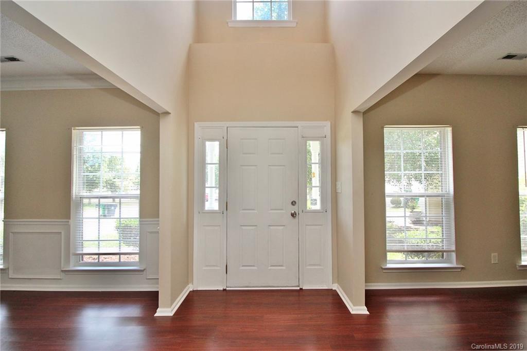 8207 Fox Swamp Road Charlotte, NC 28215 - Photo 6 of 44 a view of an empty room with wooden floor and a window