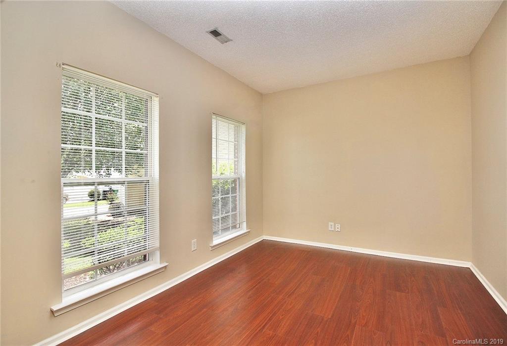 8207 Fox Swamp Road Charlotte, NC 28215 - Photo 7 of 44 an empty room with wooden floor and windows