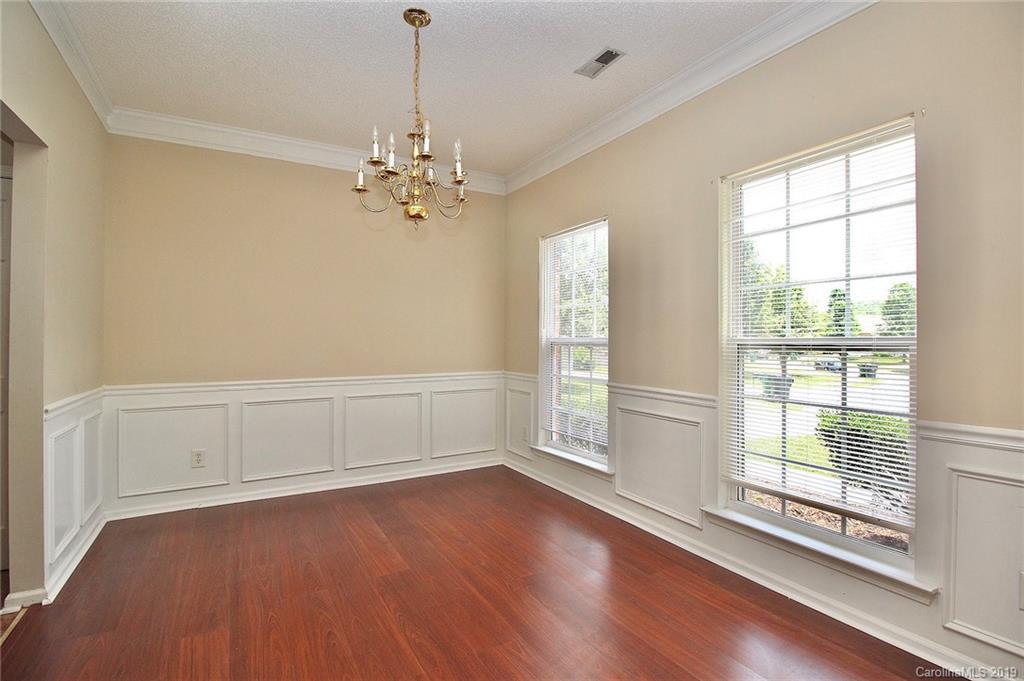 8207 Fox Swamp Road Charlotte, NC 28215 - Photo 9 of 44 a view of room with window ceiling fan and hardwood floor