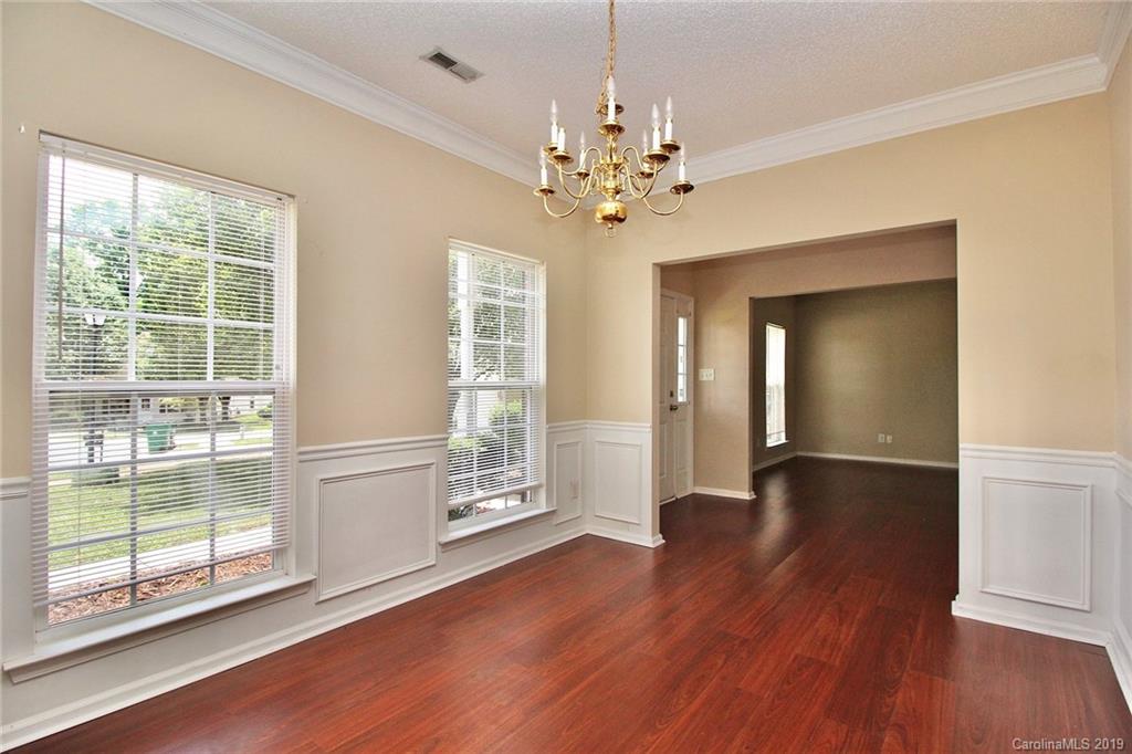 8207 Fox Swamp Road Charlotte, NC 28215 - Photo 10 of 44 a view of an empty room with wooden floor and a window