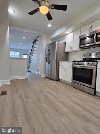a view of a kitchen with a sink and stainless steel appliances