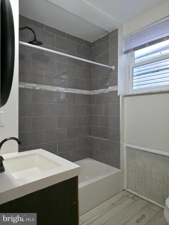 a bathroom with a sink a bathtub and a shower