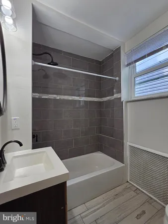 a bathroom with a sink a bathtub and a shower