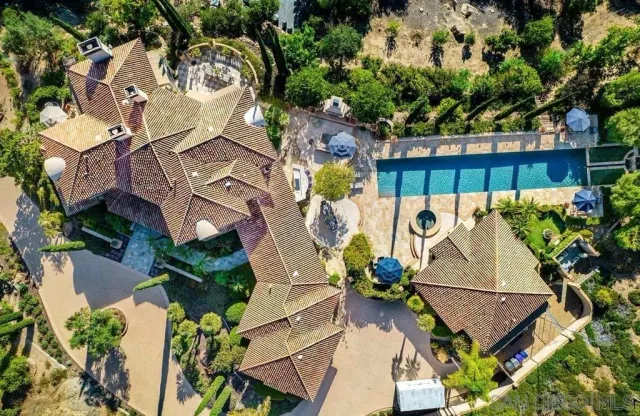 an aerial view of a house with a yard and lake view