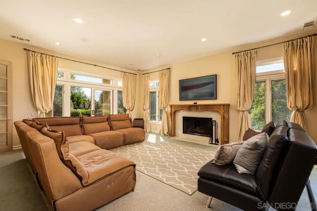 a large bathroom with a double vanity sink a large mirror and a bathtub