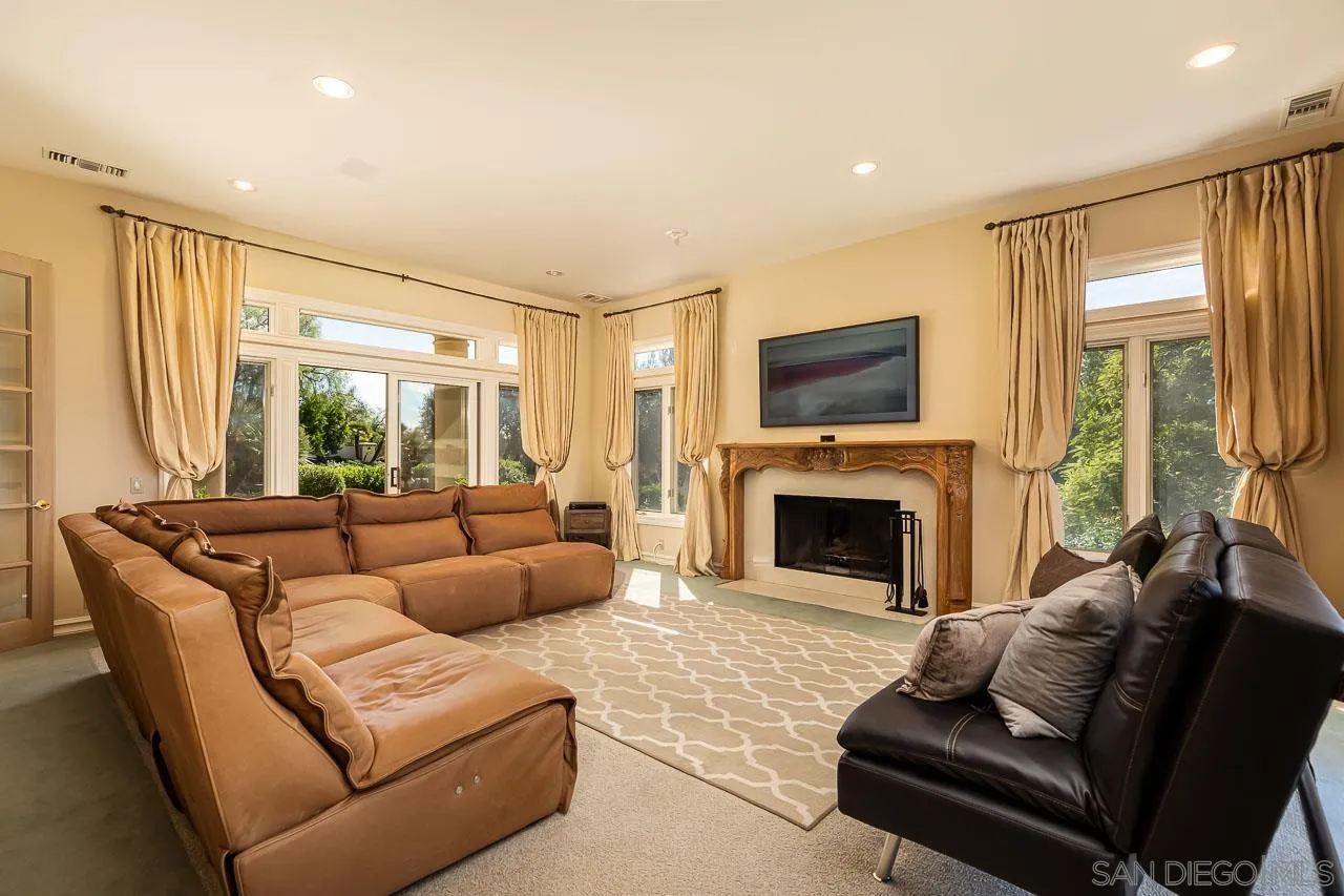14440 Ridge Ranch Road Valley Center, CA 92082 - Photo 24 of 74 a living room with furniture a fireplace and a large window