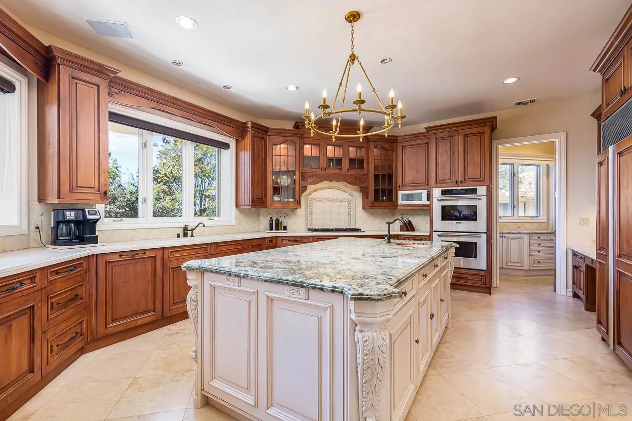 14440 Ridge Ranch Road Valley Center, CA 92082 - Photo 27 of 74 a kitchen with stainless steel appliances granite countertop a sink and a refrigerator