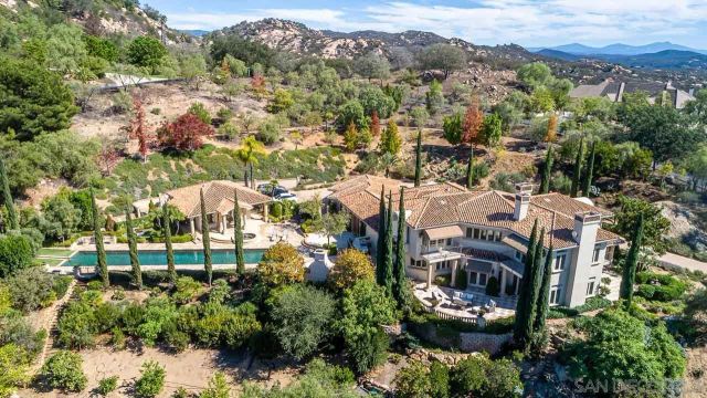 a front view of a house with garden and street view
