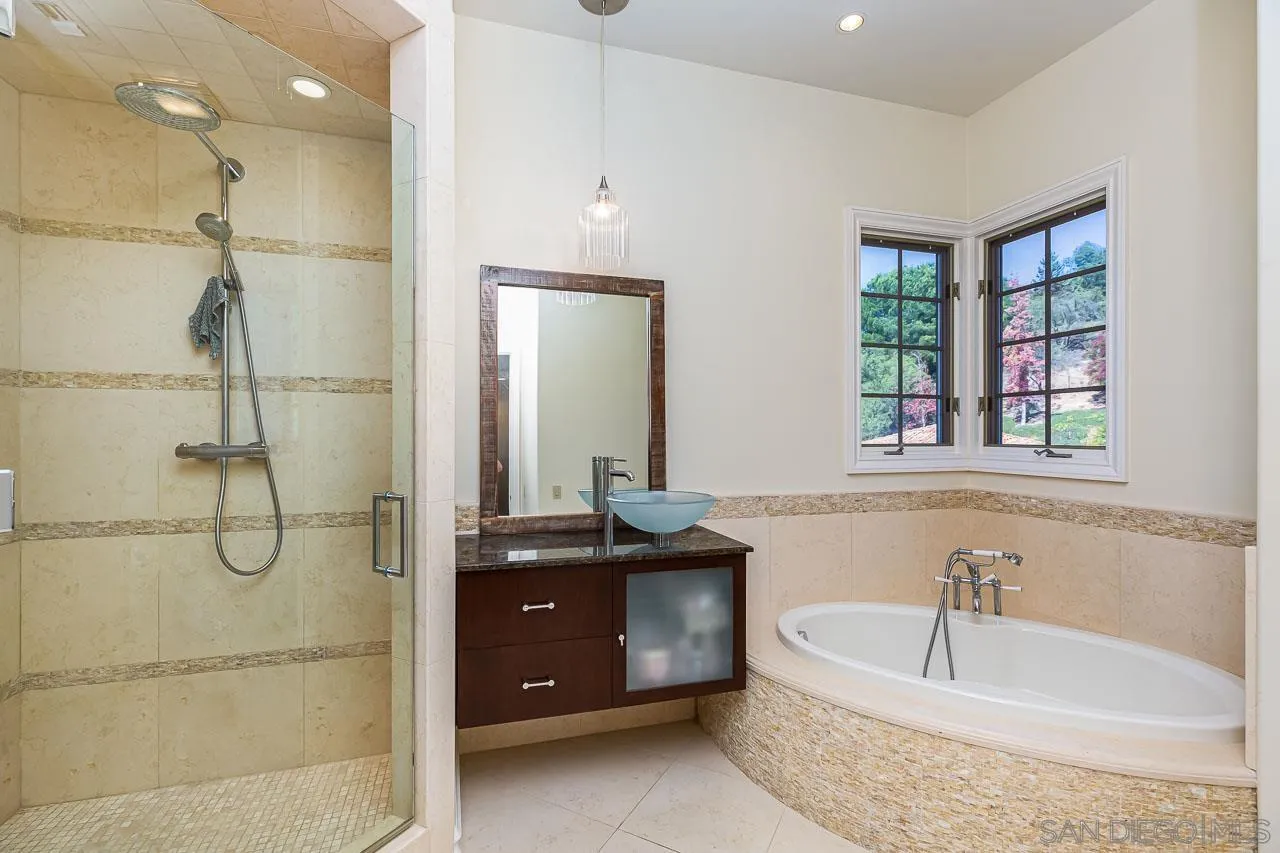 14440 Ridge Ranch Road Valley Center, CA 92082 - Photo 45 of 74 a bathroom with a tub sink and mirror