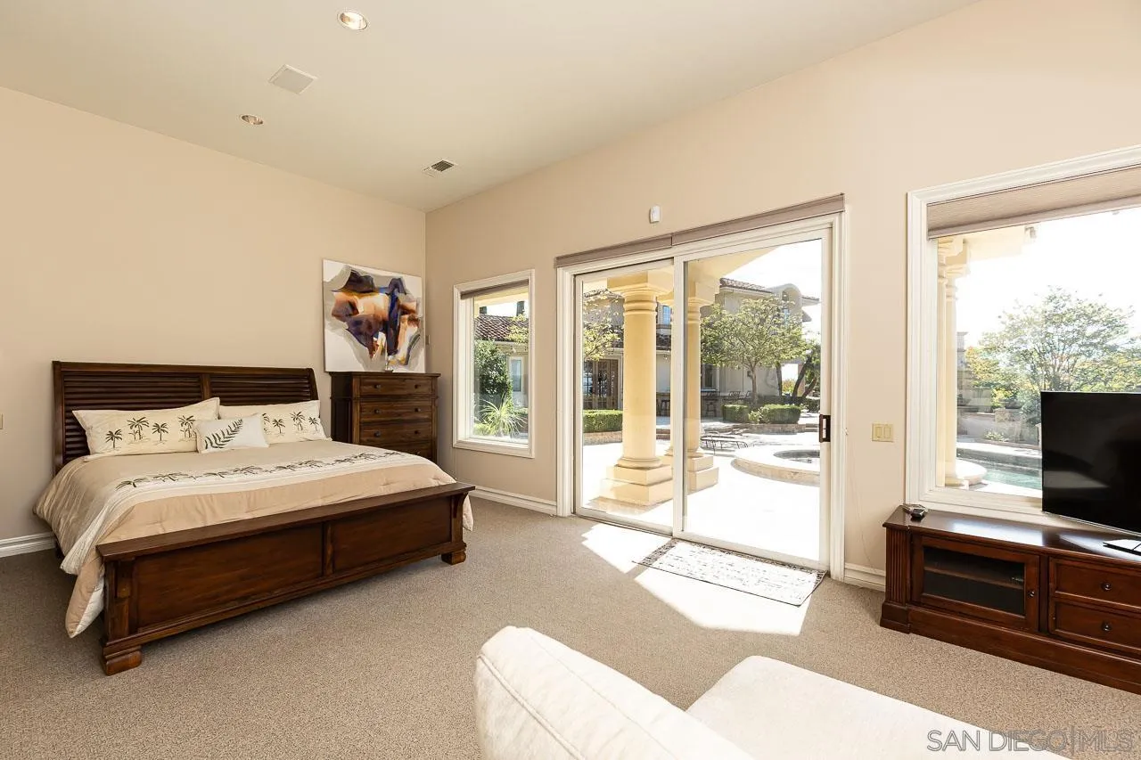 14440 Ridge Ranch Road Valley Center, CA 92082 - Photo 48 of 74 a spacious bedroom with a bed and large window