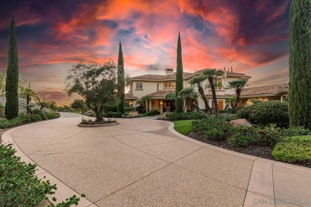 a view of a house with pool and ocean view