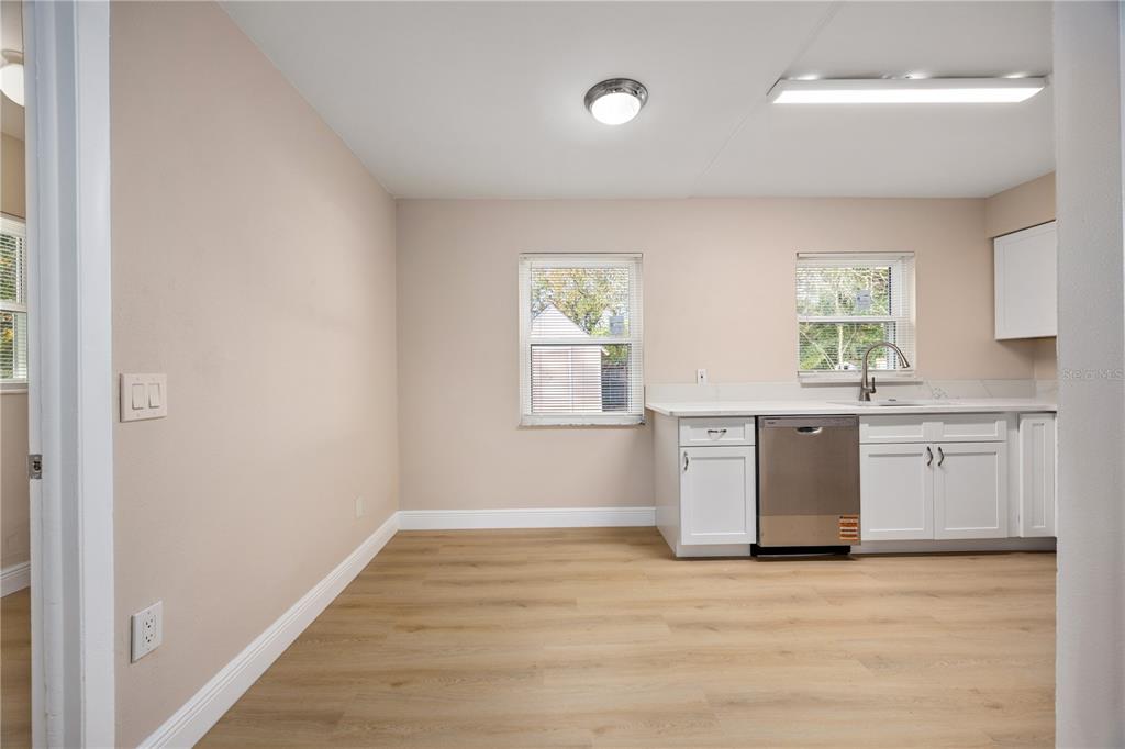 8013 Rhea Circle Orlando, FL 32807 - Photo 11 of 31 a view of a kitchen with wooden floor and electronic appliances