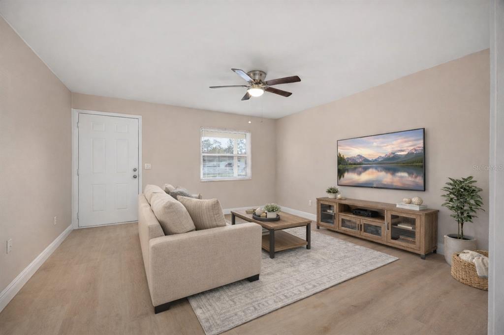 8013 Rhea Circle Orlando, FL 32807 - Photo 12 of 31 a living room with furniture and a flat screen tv