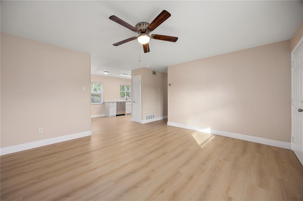 8013 Rhea Circle Orlando, FL 32807 - Photo 14 of 31 an empty room with wooden floor and windows