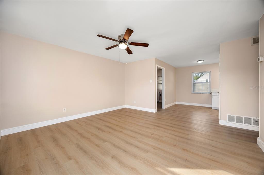 8013 Rhea Circle Orlando, FL 32807 - Photo 15 of 31 a view of empty room with wooden floor and ceiling fan