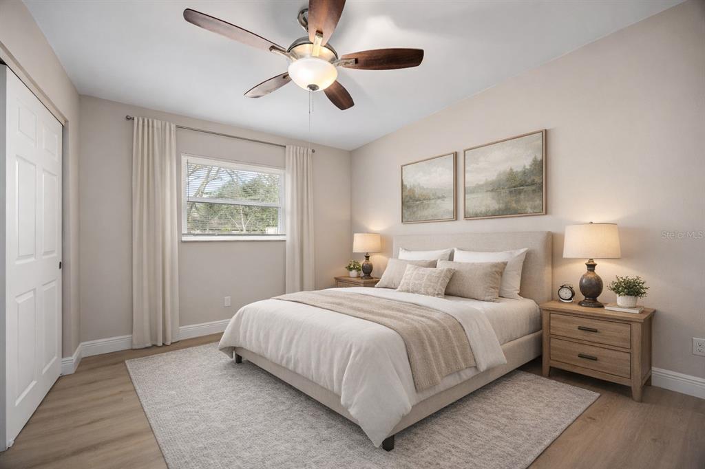 8013 Rhea Circle Orlando, FL 32807 - Photo 17 of 31 a bedroom with a large bed and a window