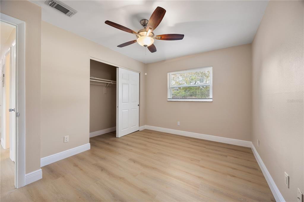 8013 Rhea Circle Orlando, FL 32807 - Photo 19 of 31 wooden floor in an empty room with a window