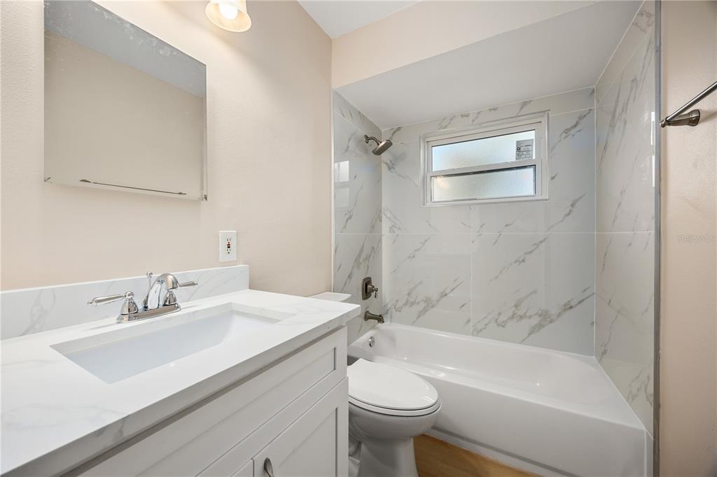 8013 Rhea Circle Orlando, FL 32807 - Photo 20 of 31 a bathroom with a sink mirror toilet and bathtub