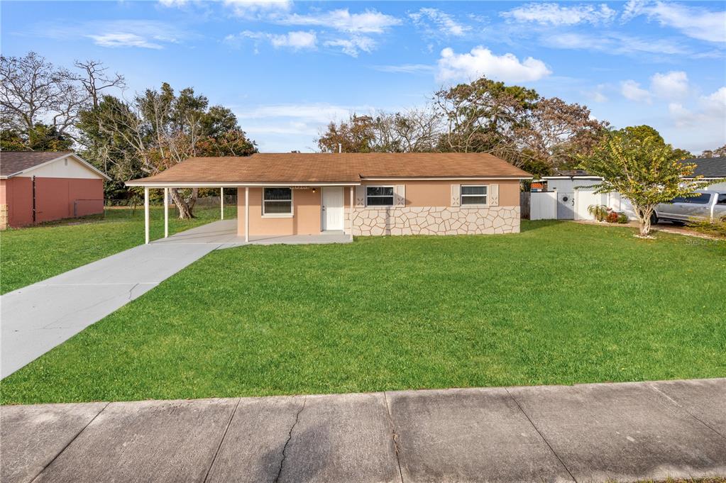 8013 Rhea Circle Orlando, FL 32807 - Photo 2 of 31 a front view of a house with a garden