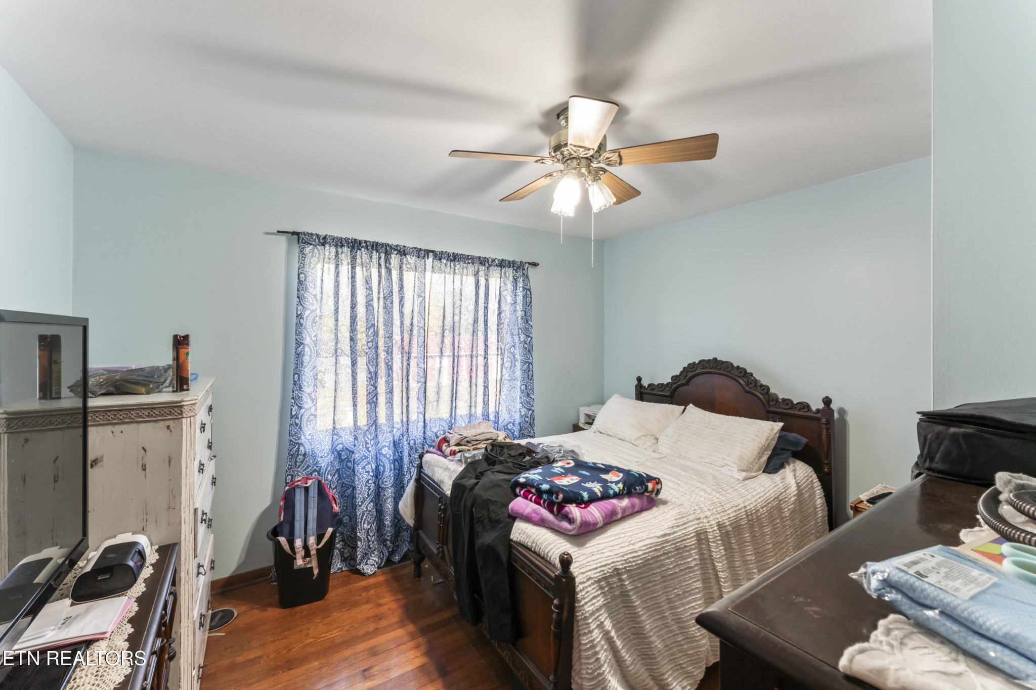 3856 Niles Ferry Road Greenback, TN 37742 - Photo 38 of 44 a bedroom with a bed and a chandelier