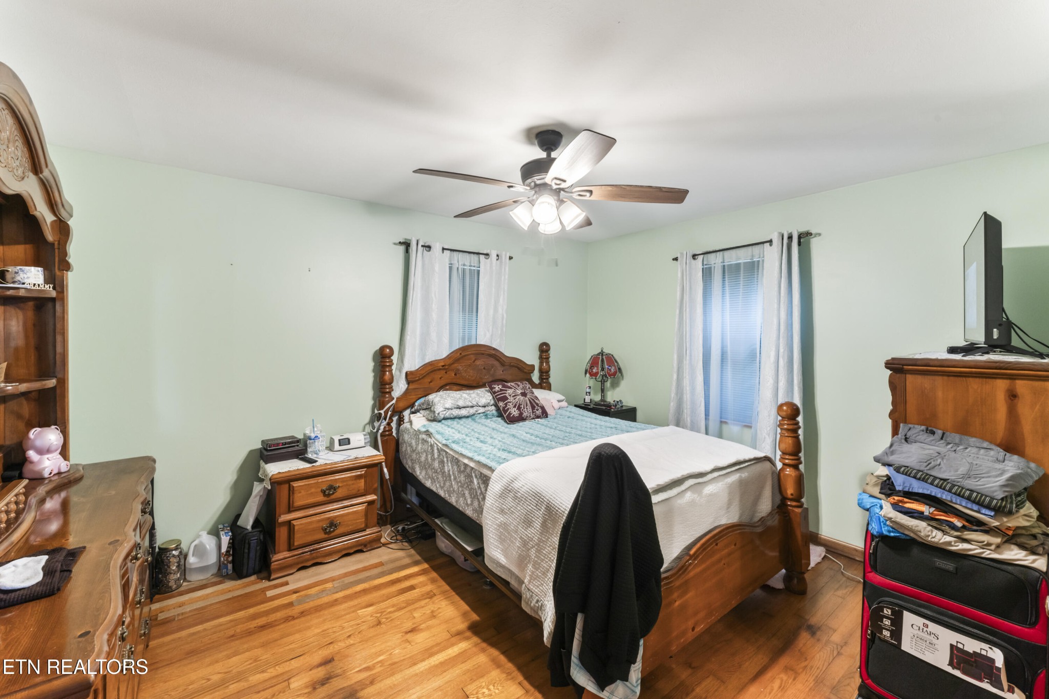 3856 Niles Ferry Road Greenback, TN 37742 - Photo 42 of 44 a bedroom with a bed and a chandelier