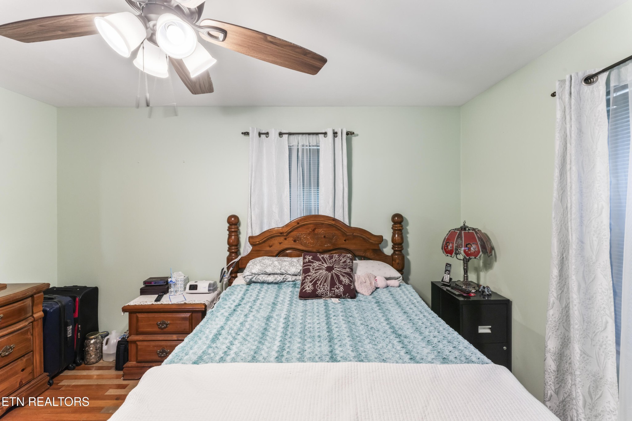3856 Niles Ferry Road Greenback, TN 37742 - Photo 43 of 44 a bedroom with a bed and a chandelier