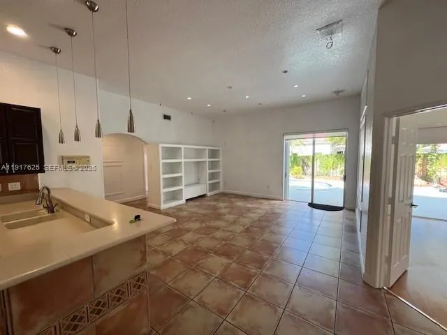 a view of a kitchen with a sink and a window