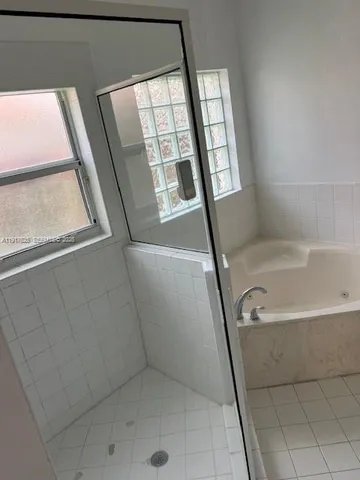 a bathroom with a bathtub a toilet and a shower