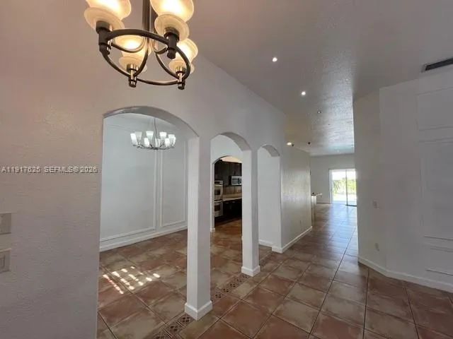 a view of a hallway with chandelier